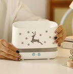 Ivory white elk diffuser base with deer silhouette and snowflake pattern; hands adjusting top