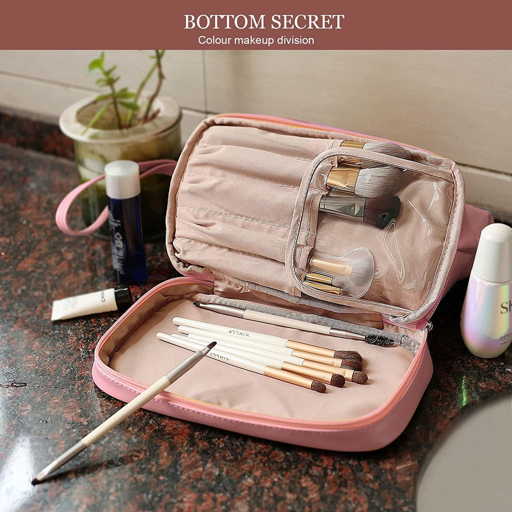 Pink cosmetic case with clear top window, open compartments, makeup brushes inside