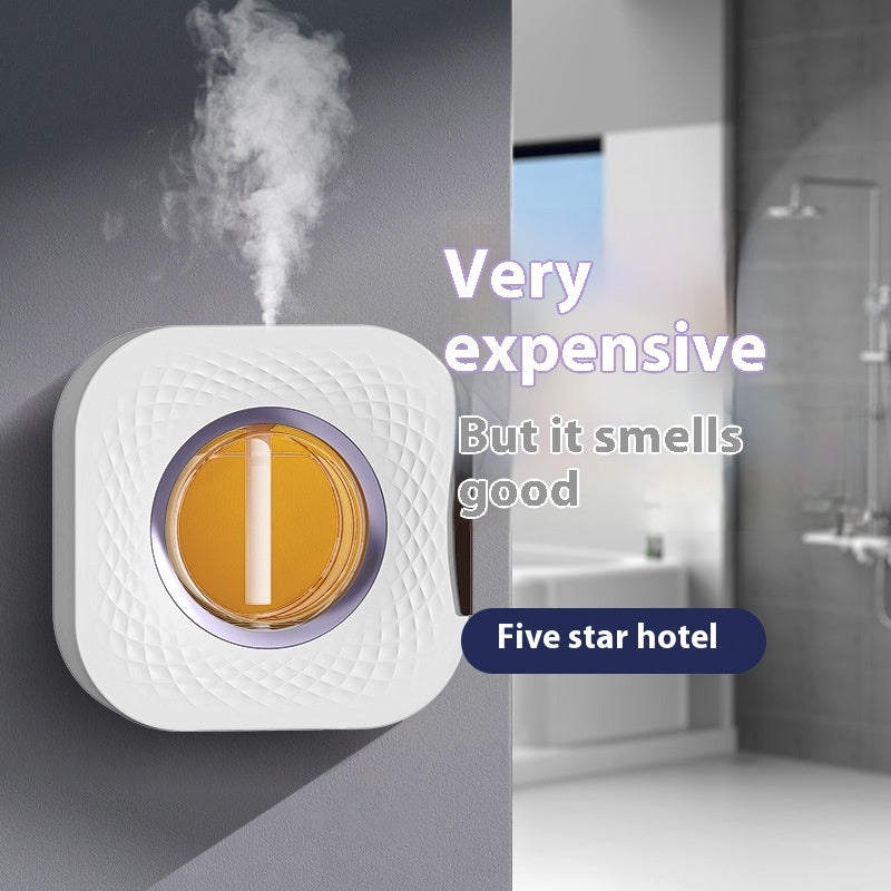 Wall-mounted white aerosol diffuser with amber circular light and mist plume
