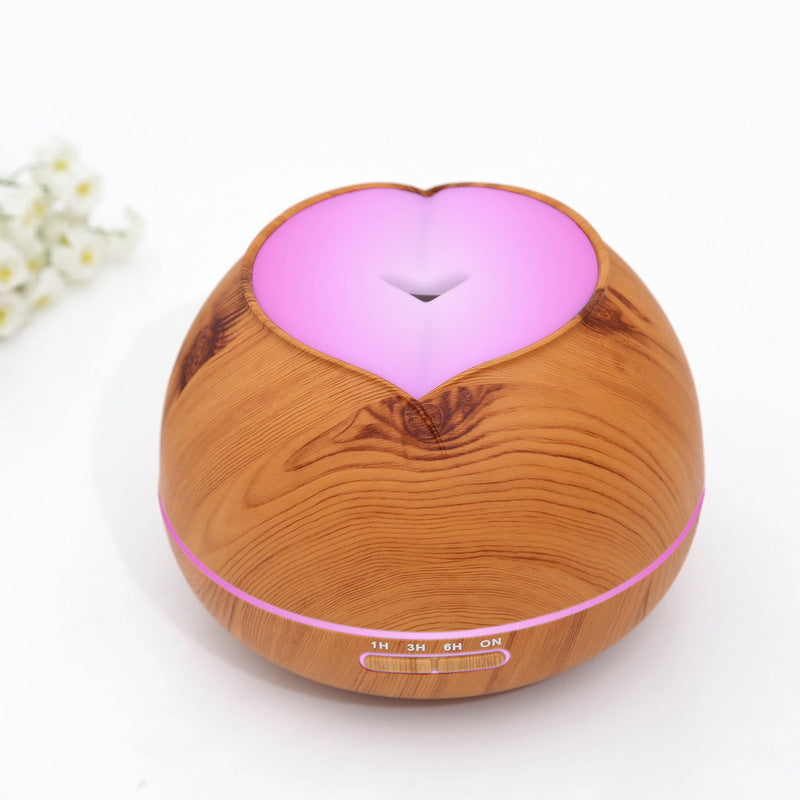 Wood grain aroma diffuser with pink glowing heart and light indicator bar