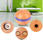 Wood essential oil diffuser releasing mist with close-ups of controls and mist outlet