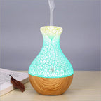 Wood grain aroma diffuser with glowing teal crackle top and light wood base