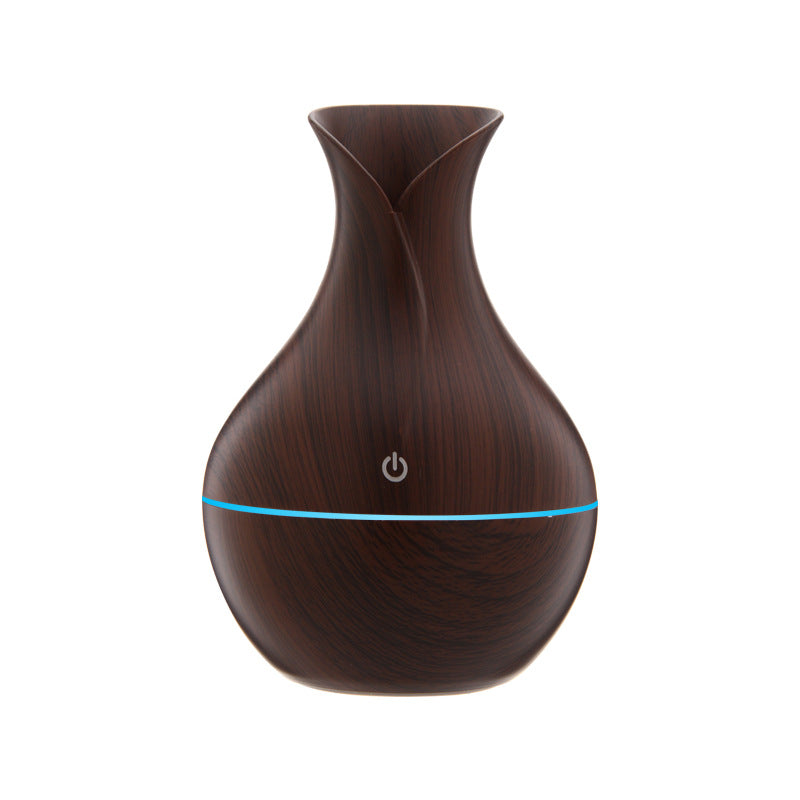 Dark wood grain aroma diffuser with soft blue light line and power icon