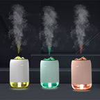 USB aroma diffuser with mist, showing white, light green, and pink bases and glow tray