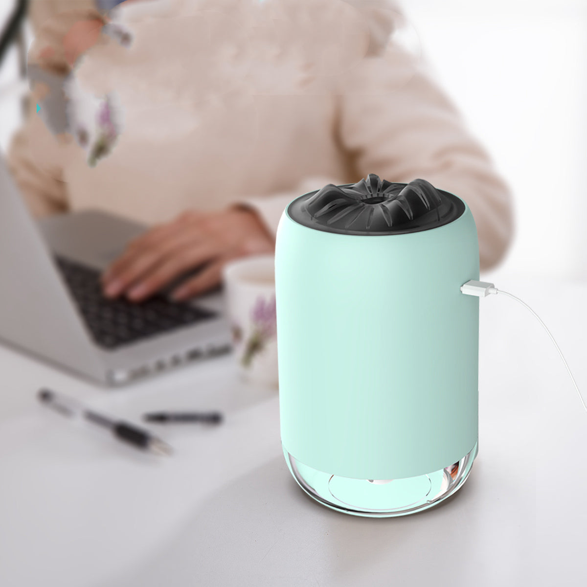 Light blue USB aroma diffuser with top nozzle, mist output, and side USB cable