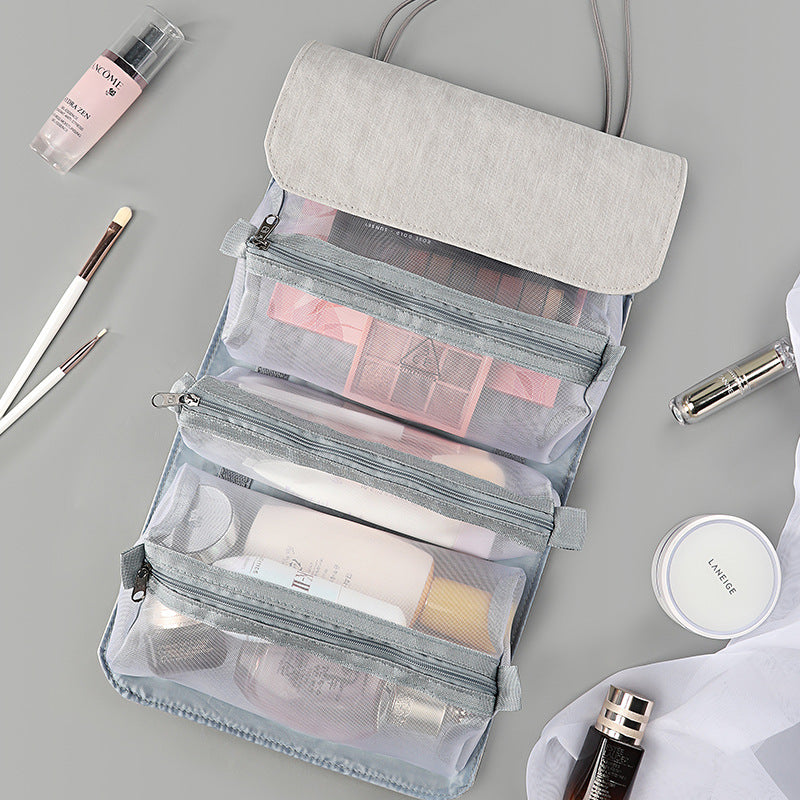Gray fold-out travel cosmetic organizer with clear mesh pouches and top flap