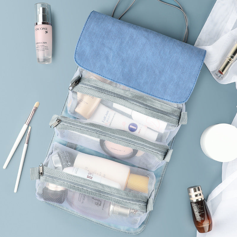 Blue fold-out travel cosmetic organizer with clear mesh compartments and zipper front