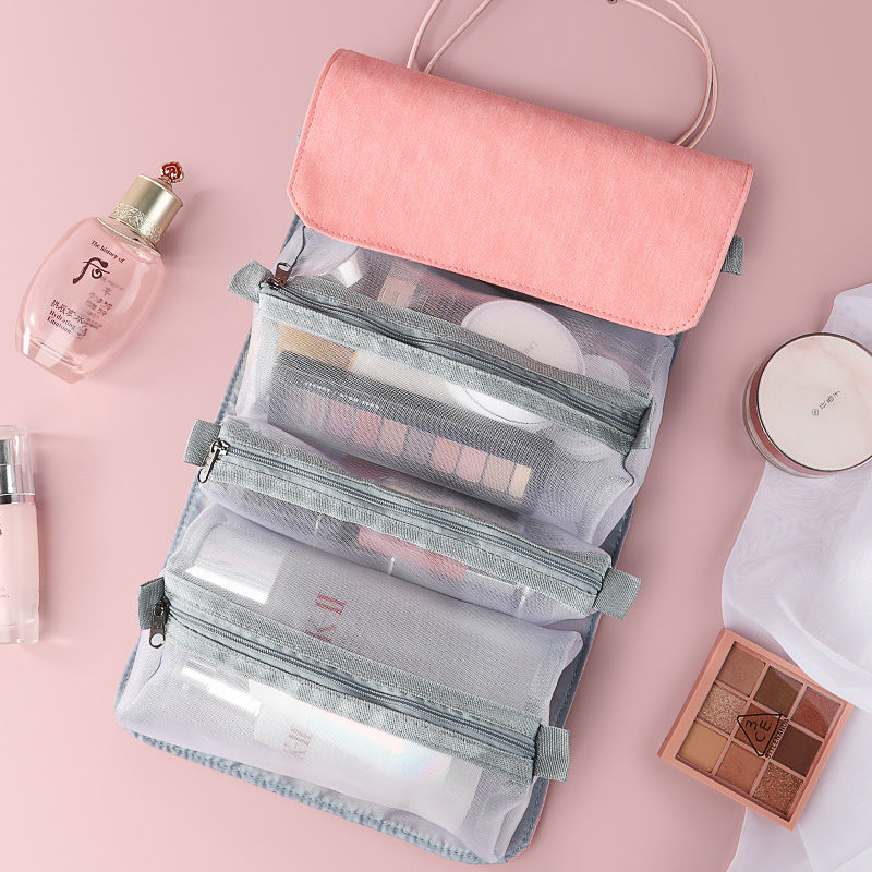 Pink fold-out travel cosmetic organizer with clear mesh compartments and top flap