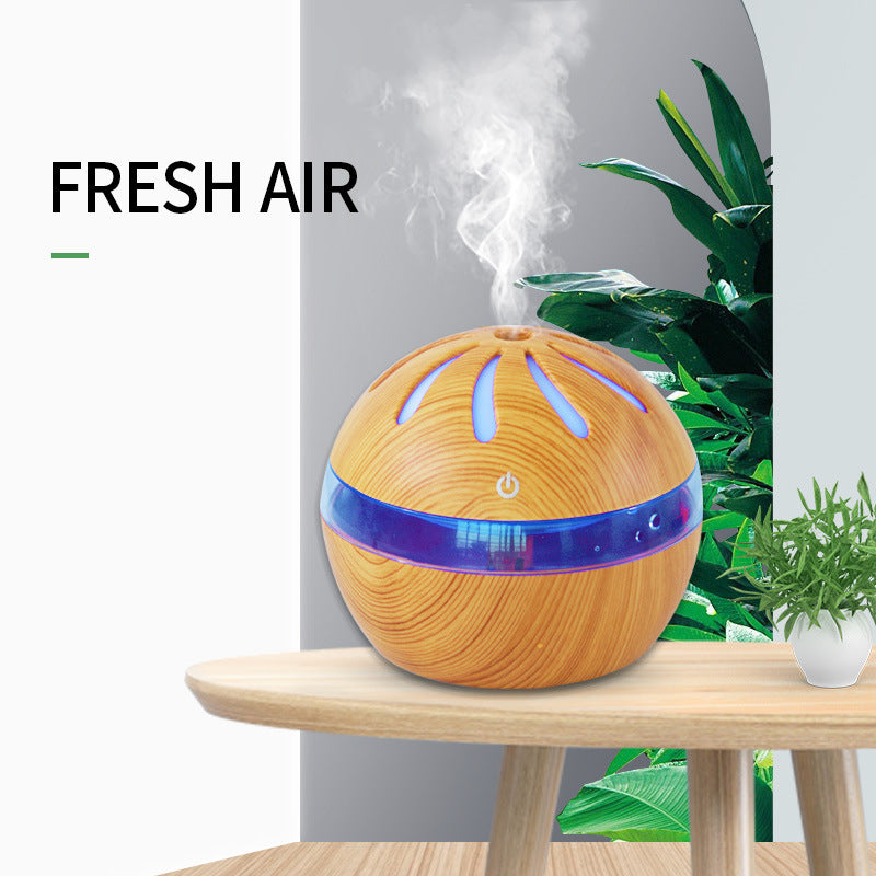 Light brown wood-grain mist diffuser with blue LED base ring and soft vapor