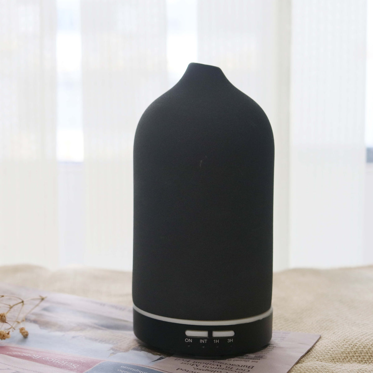 Dark gray ceramic aroma diffuser with rounded top and base control buttons