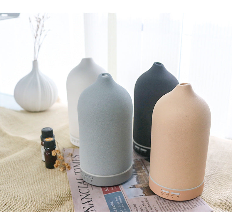 Set of ceramic aroma diffusers in light gray, dark gray, and beige with base controls