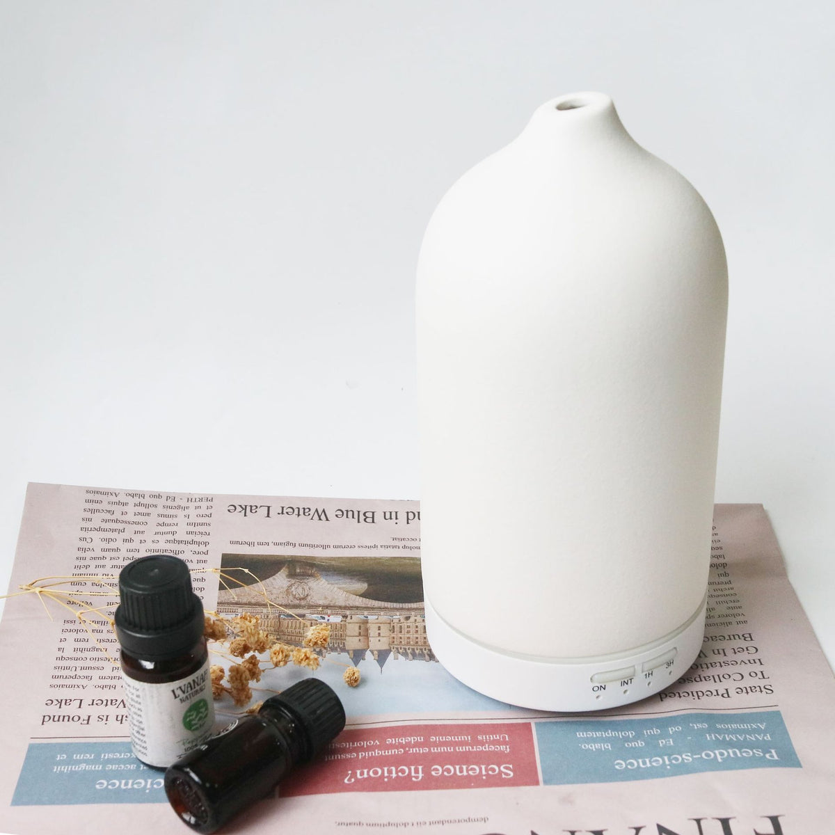 White ceramic aroma diffuser with rounded top and base control buttons