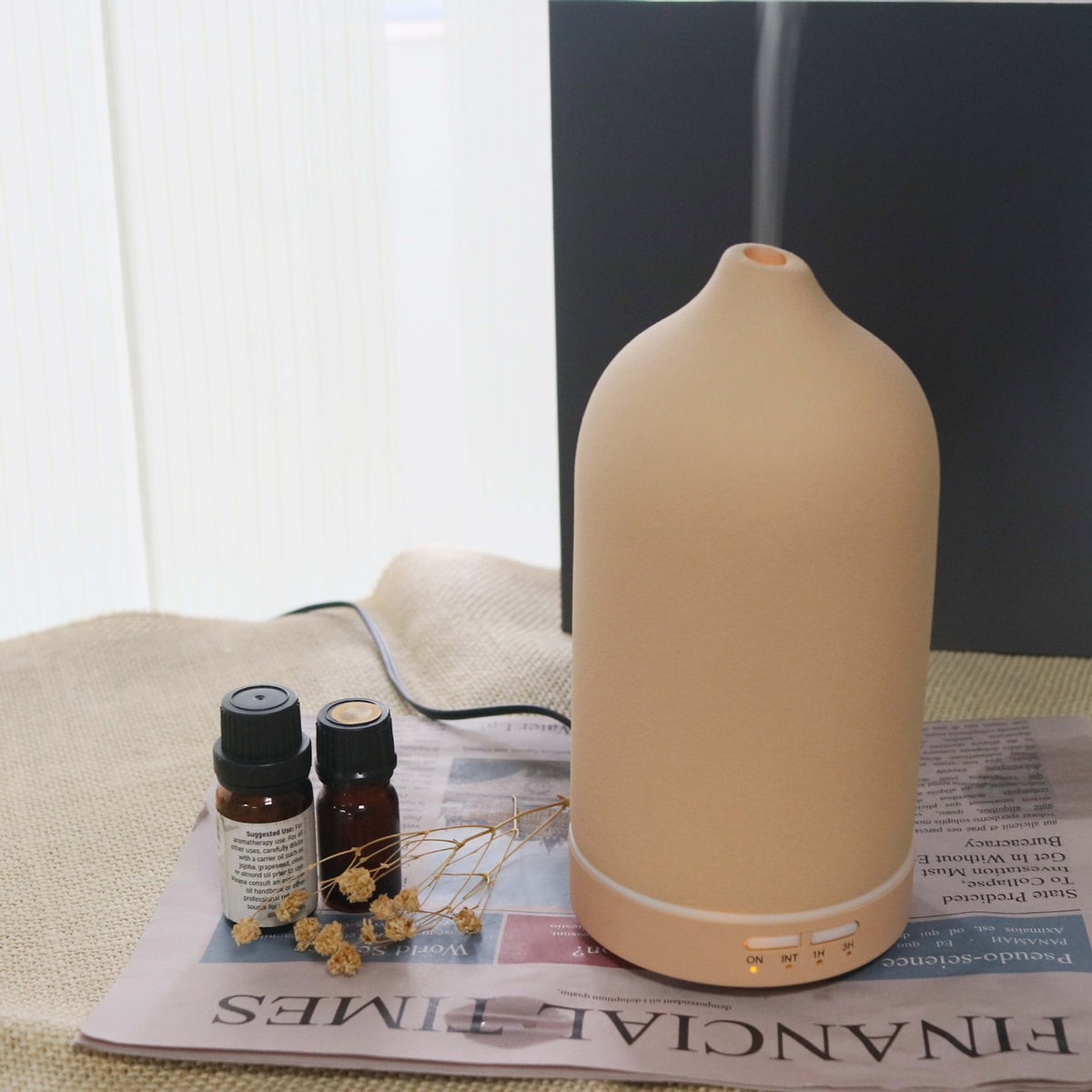 Beige ceramic aroma diffuser with rounded top and base control buttons