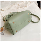 Green crossbody travel bag with snap buttons, ruched top, and adjustable strap