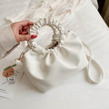Offwhite compact crossbody travel bag with ruched drawstring top and shoulder strap