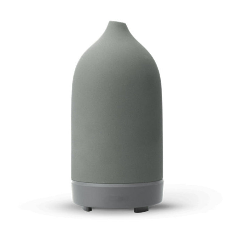 Ceramic aroma diffuser in gray, tall tapered bottle with silver ring and feet