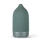 Ceramic aroma diffuser in teal green, smooth bottle with silver ring and base feet