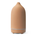 Ceramic aroma diffuser in beige, smooth bottle with silver ring and base feet