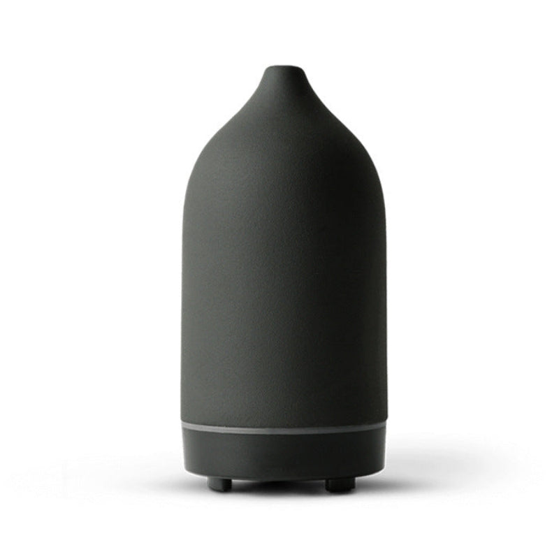 Ceramic aroma diffuser in black, rounded bottle silhouette with base and 2 feet