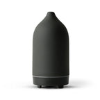 Ceramic aroma diffuser in black, rounded bottle silhouette with base and 2 feet