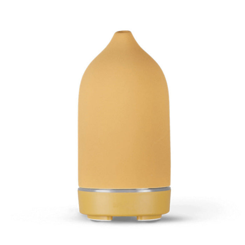Ceramic aroma diffuser in yellow, matte bottle shape with silver collar and feet