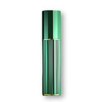 Gold travel perfume atomiser in a hand, mist plume emerging from the spray head