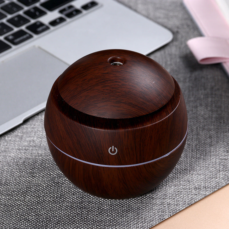 Wood grain aroma diffuser, dark round container with circular top opening and power icon
