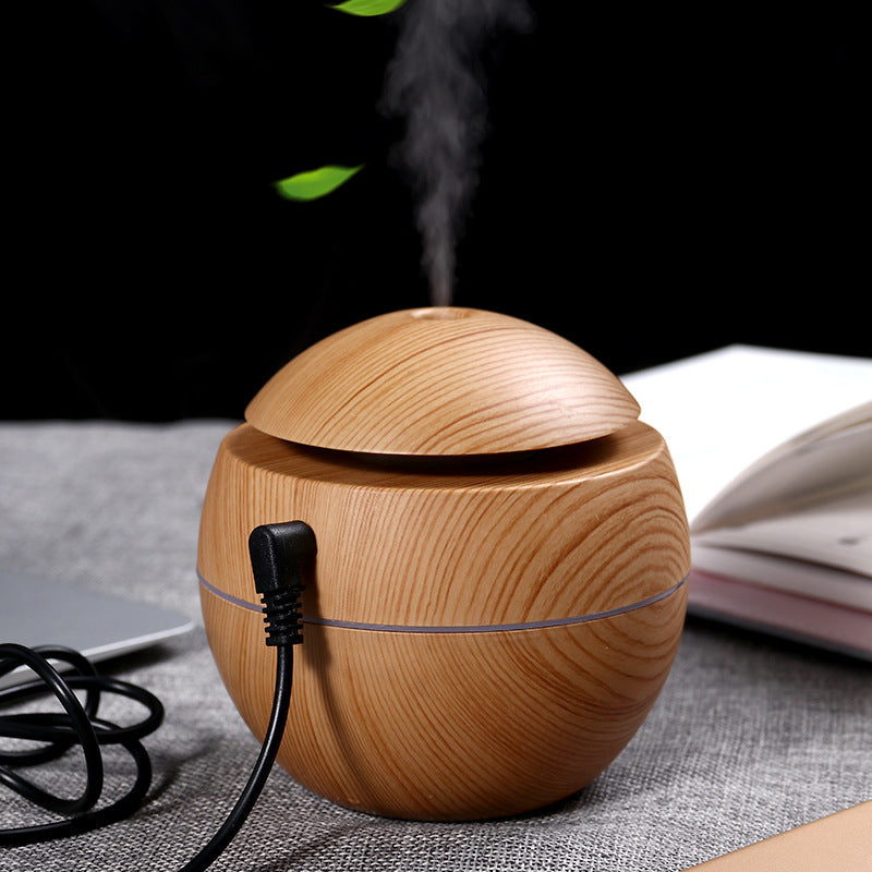 Wood grain aroma diffuser, light wood sphere with mist plume and connected power cable