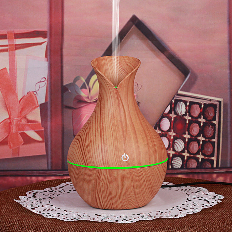 Wood grain aroma diffuser, light teardrop shape with green glowing power ring and mist