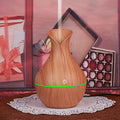 Wood grain aroma diffuser, light teardrop shape with green glowing power ring and mist