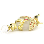 Perfume oil vial with clear nozzle tip, gold cap, white body with red gem accents