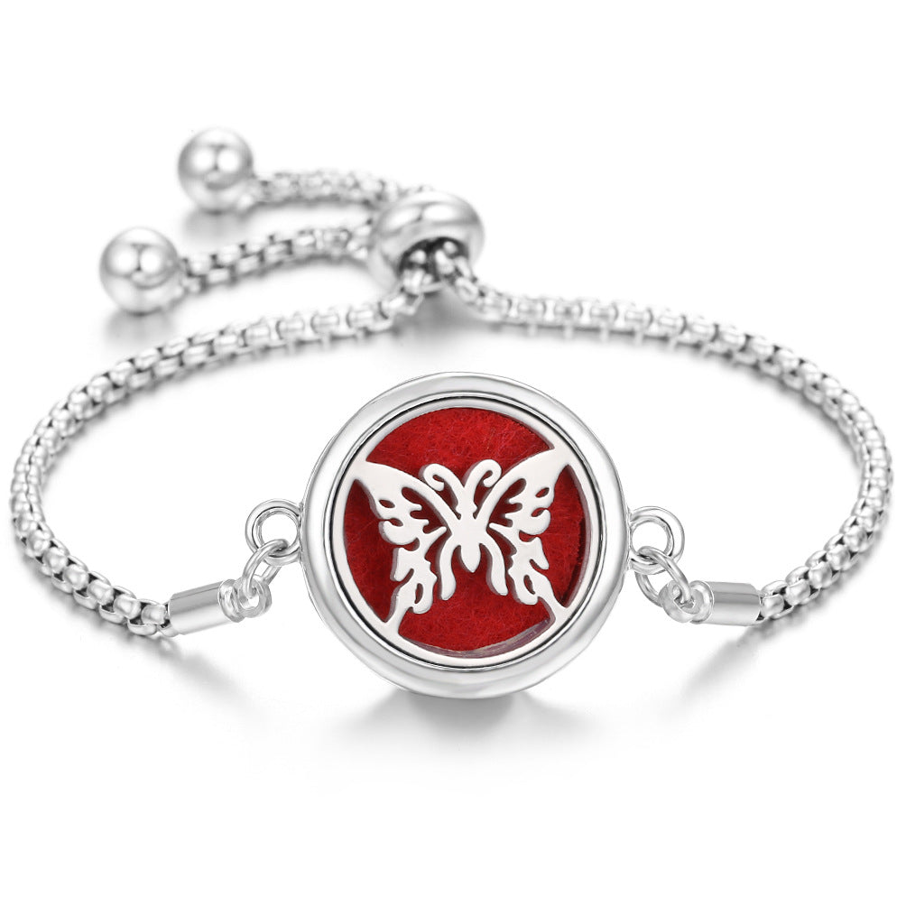 Silver-tone Ritual Aroma Bracelet with red round locket and butterfly design