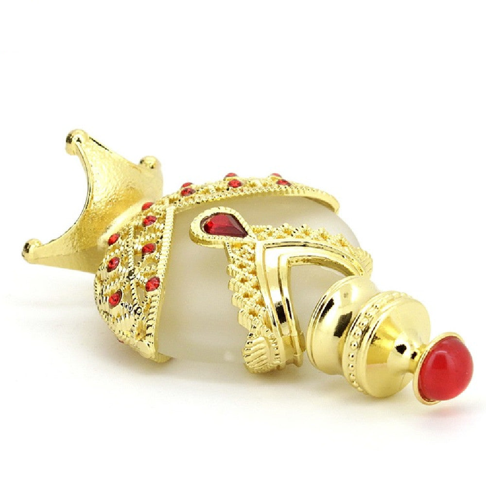 Perfume oil vial with gold star-like base, gold collar, red cap accents on white body