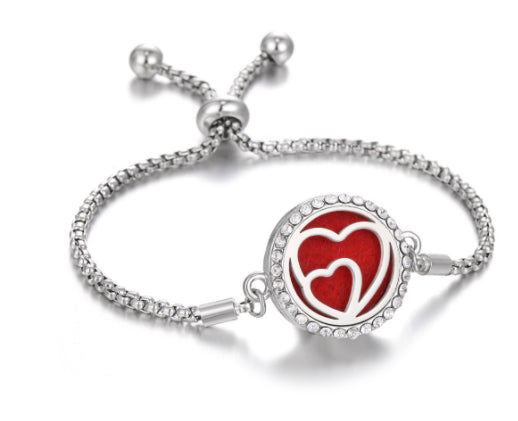 The Ritual Aroma Bracelet in silver tone with red heart locket