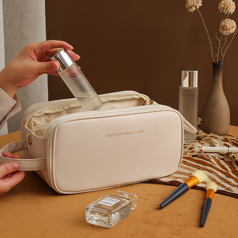 White structured travel vanity case with zip front and wrist strap, cosmetics bottle inside