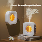White aerosol scent diffuser machine with glowing amber circular nozzle window
