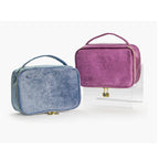 Soft travel cosmetic cases with top handles and gold zipper hardware, purple and blue