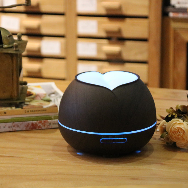 Dark wood grain aroma diffuser with glowing heart light and blue light ring