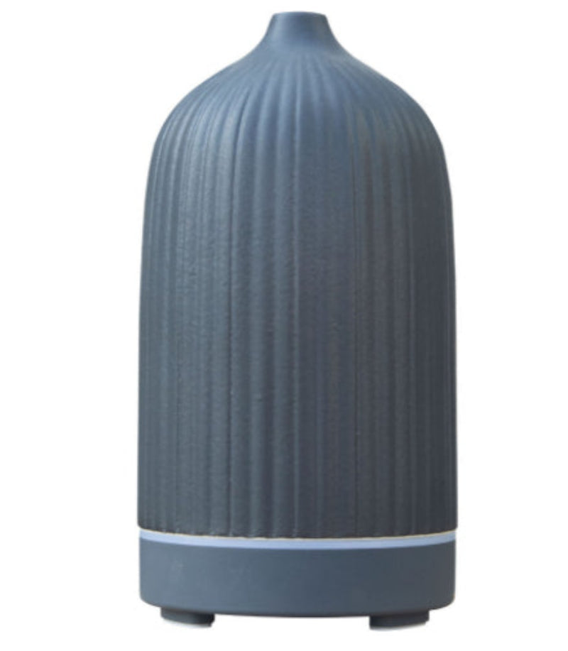Textured blue ceramic aroma diffuser, ribbed bottle with base and small feet