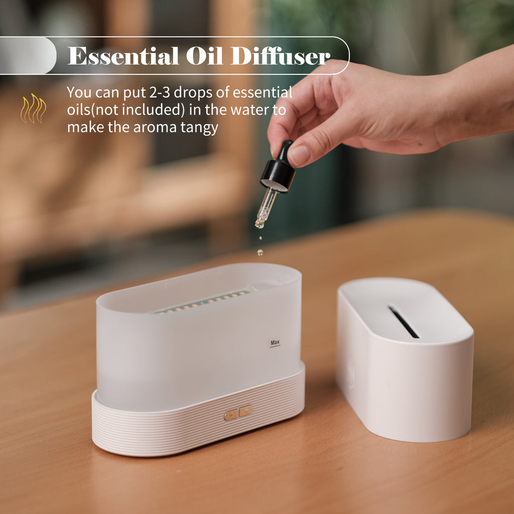White flame mist diffuser with hand adding oil drop from dropper