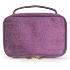 Soft travel cosmetic case in purple with top handle and gold zipper pull