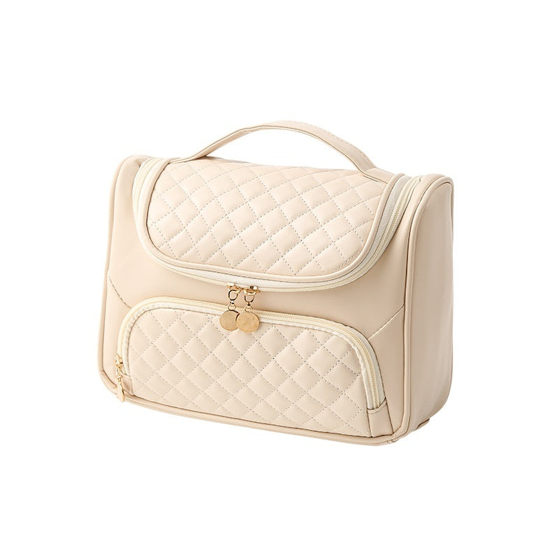 Vanity bag with quilted top and front zip pocket, cream color and carry handle