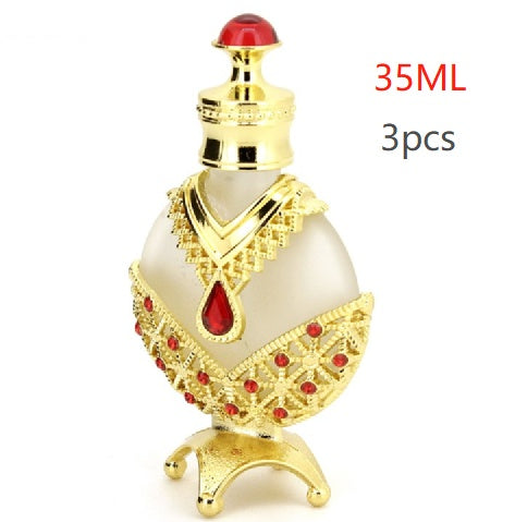Perfume oil vial with red cap and gold filigree, white body with red gem pattern