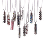 Set of Aroma pendant cylinders with different decorative openings in blue, red, black designs