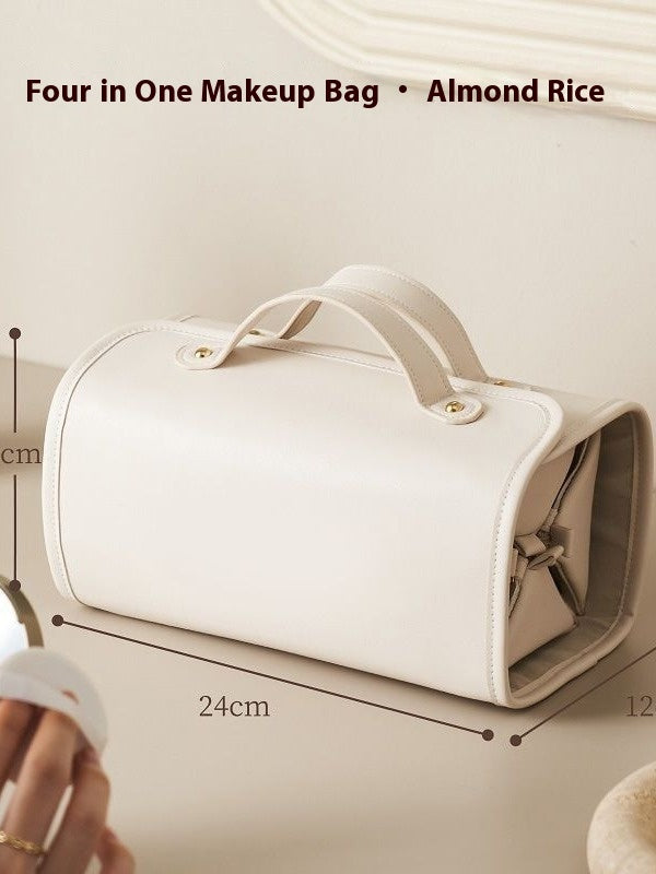White folding travel vanity bag with two top handles and gold-tone snap clasp.