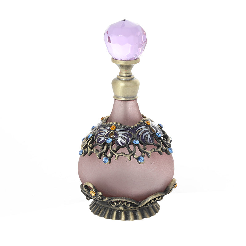 Perfume oil bottle with purple faceted cap, mauve glass, and blue floral metal band