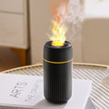 Black aroma diffuser with vapor plume from top nozzle, front view.