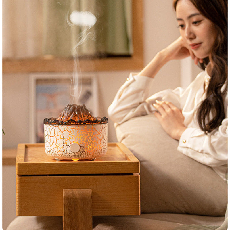 Volcano mist jellyfish diffuser on nightstand, glowing orange mist in use