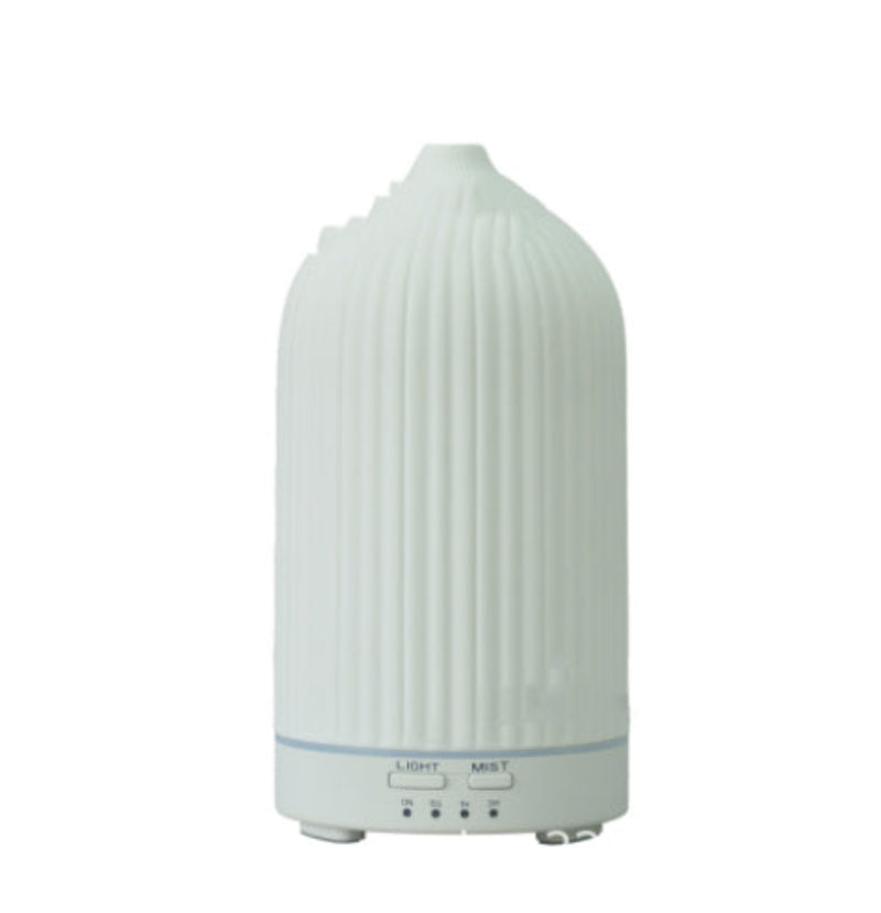 Textured white ceramic aroma diffuser with control panel showing Light and Mist options