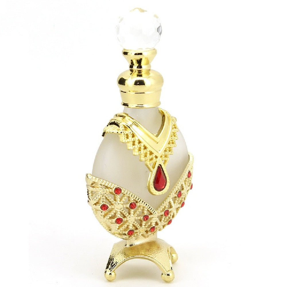 Perfume oil vial with red teardrop emblem, red gem insets, white body and crystal top
